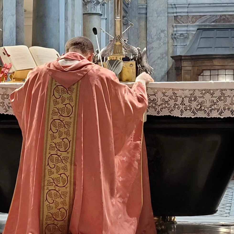 Genuflecting before the relic of the True Cross in the Basilica of Santa Croce in Gerusalemme. Credit: Erick M.